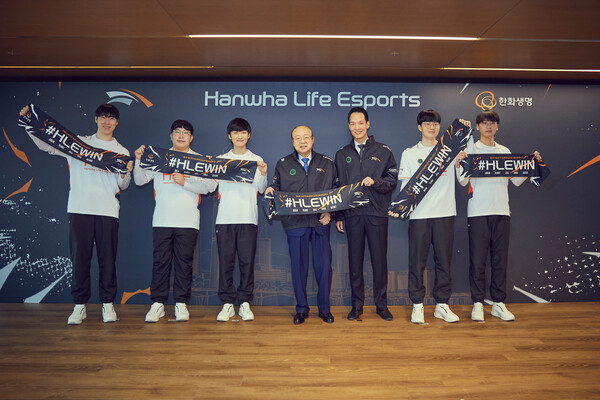 한화그룹 김승연 회장이 한화생명 e스포츠게임단인 ‘HLE’ 선수단의 선수들과 함께 유니폼을 걸치고 단체사진을 찍고 있다.