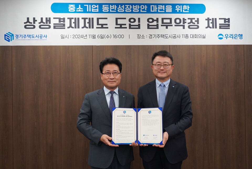 지난 6일 경기주택도시공사에서 열린 '상생결제제도 도입 업무약정' 체결식에서 조세형 우리은행 기관그룹 부행장(오른쪽)과 안상태 경기주택도시공사 경영기획본부장(왼쪽)이 기념 촬영을 하고 있다.